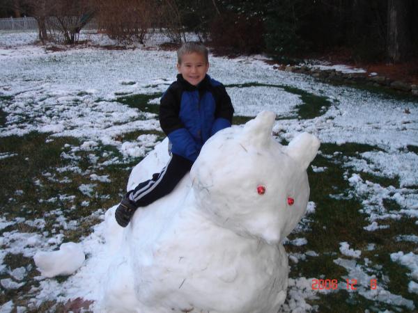 andrew on snow cat 001 this is a snow cat or bear i made for my son. that was all the snow that was on the ground that day no one could believe i made this out of so little snow. It was exhausting gathering the snow from the yard. but my son loved it